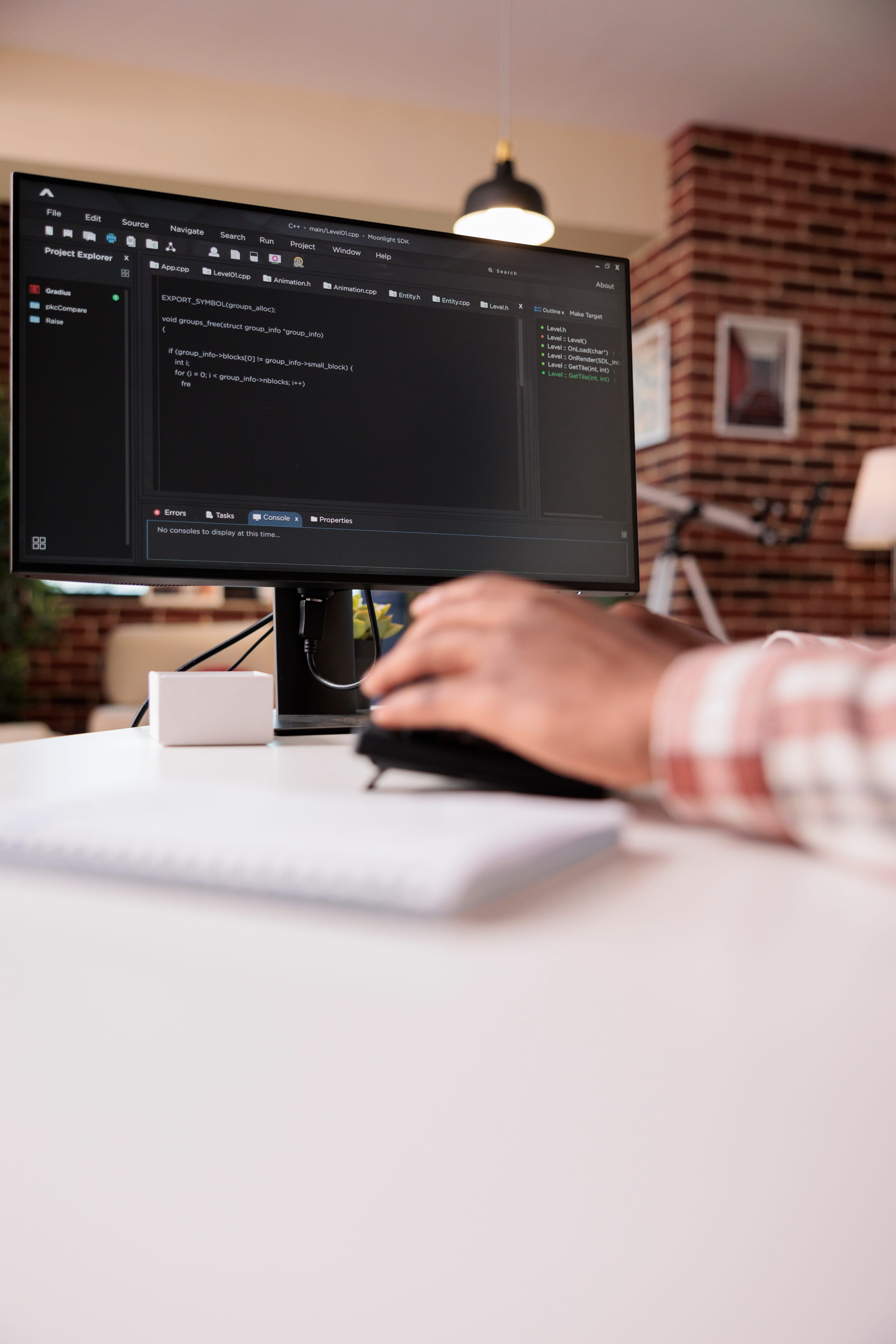 Tim Withrow at a desk, coding on a monitor